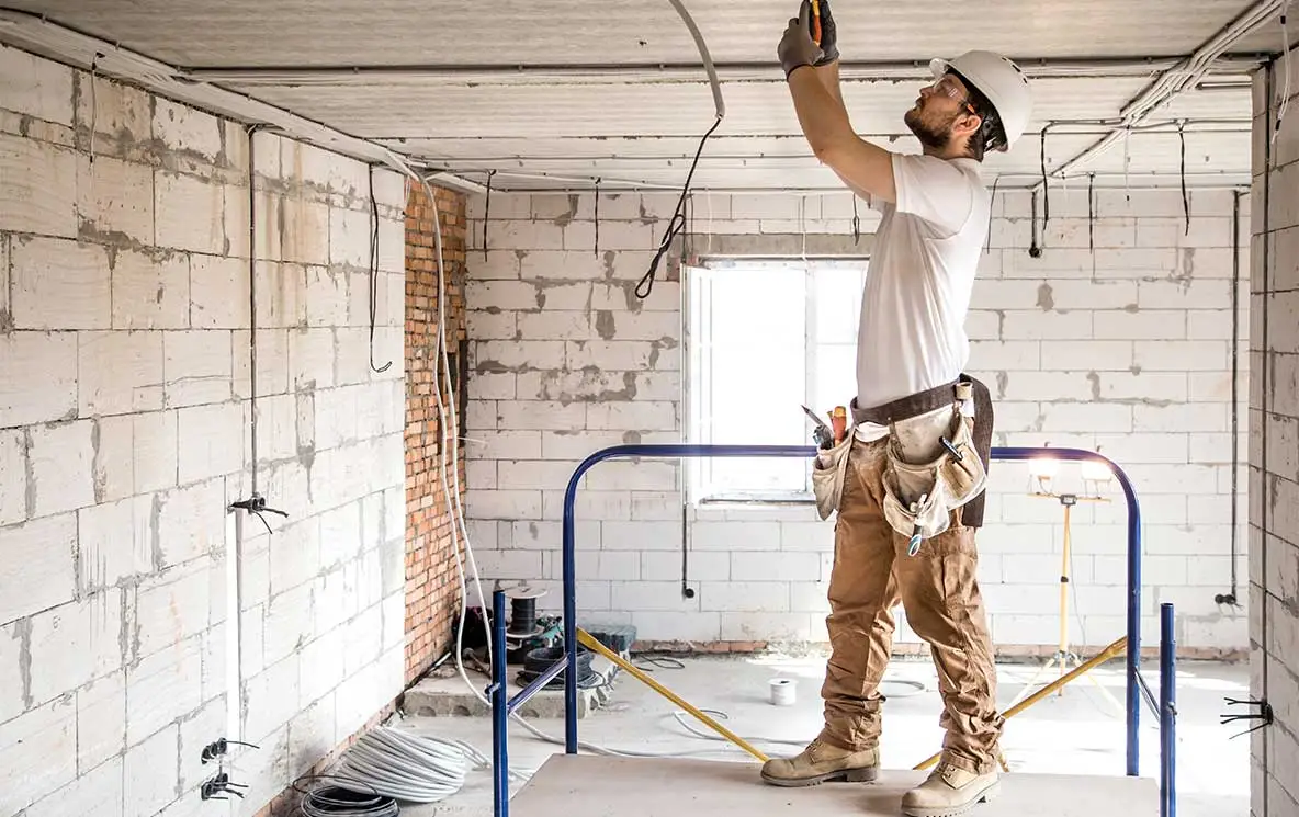 Electrician installer with a tool in his hands